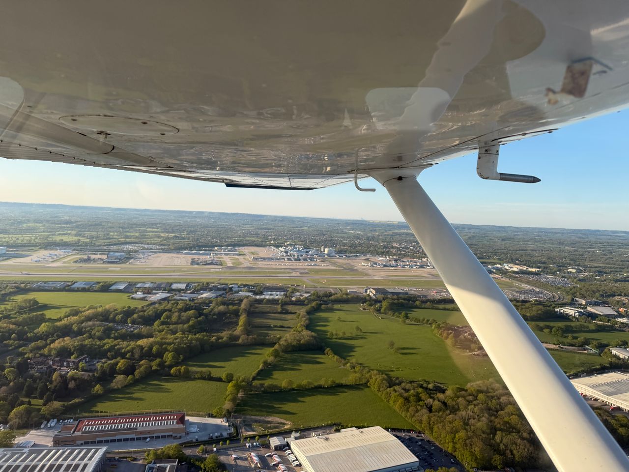 In flight picture out of the window of G-MFLM a Cessna 152 operated by STAR Flight Training looking at London Gatwick Airport