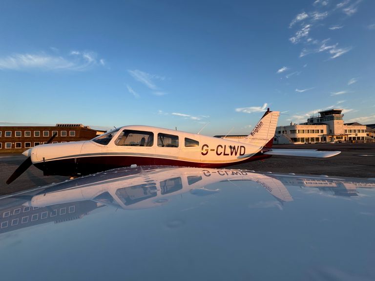 The upper left wing of a STAR Flight Training PA28, G-CLWD at sunset 