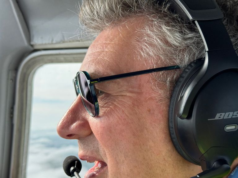 Our instructor Mark in flight with a Bose Headset and sunglasses