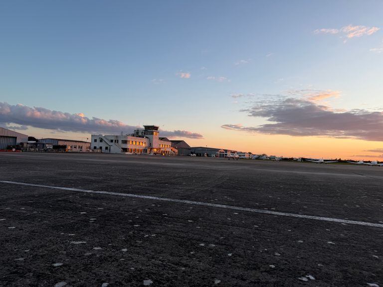 The art deco Brighton City Airport main terminal building at sunset as seen from the apron